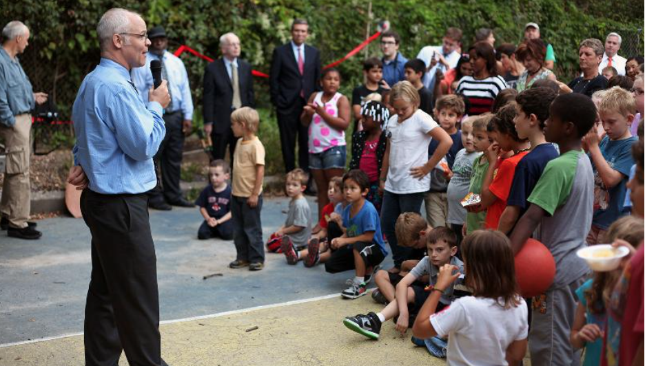 Children and adults gathering outdoors at Manning School